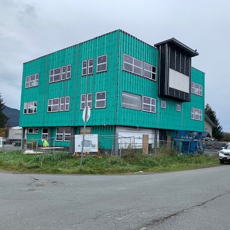 teal street center under construction with green weather wrapping.